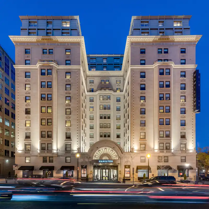 Night photo of the Hamilton Hotel from the street.