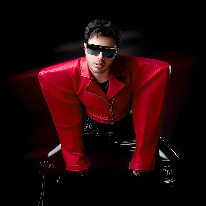 MkX is pictured in a bright red large-shoulder leather jacket